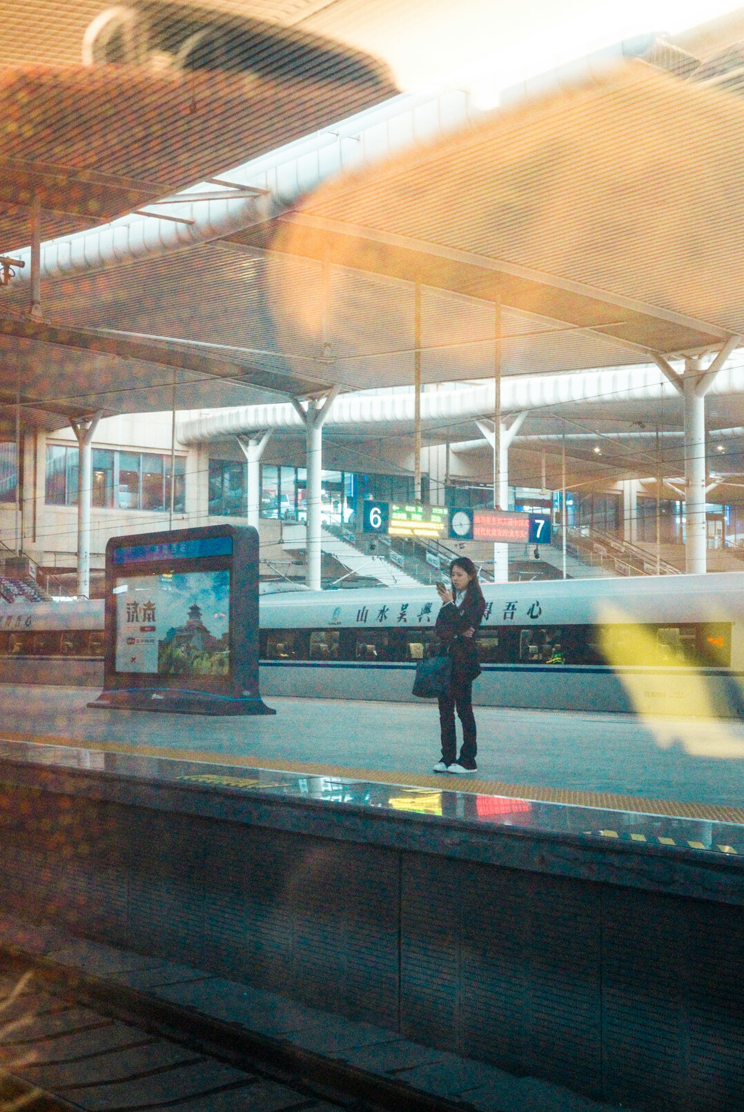 young person waiting at station