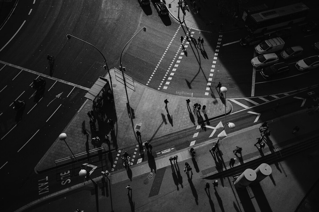 pedestrians crossing busy street