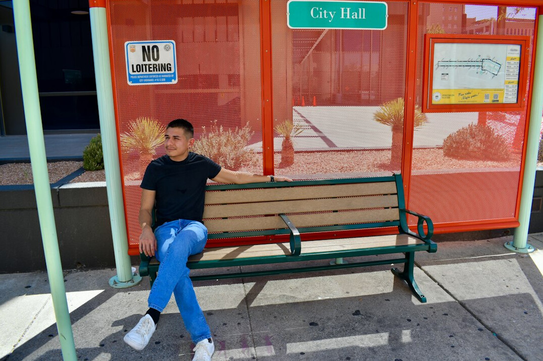 people waiting at bus stop in city